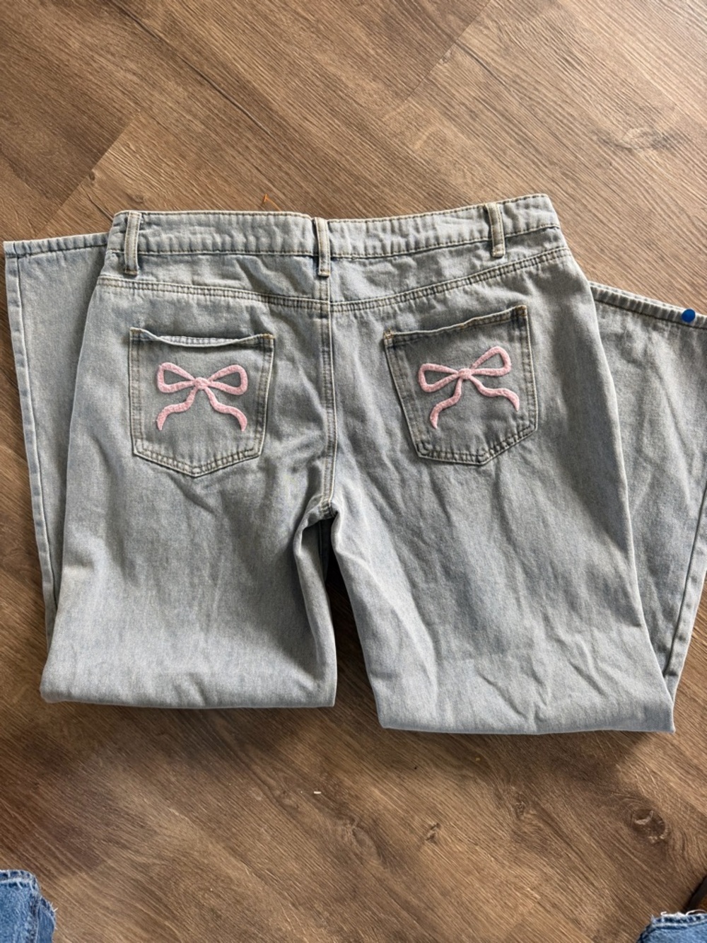 Edikted Light Wash Jeans with Pink Bow Back Pockets